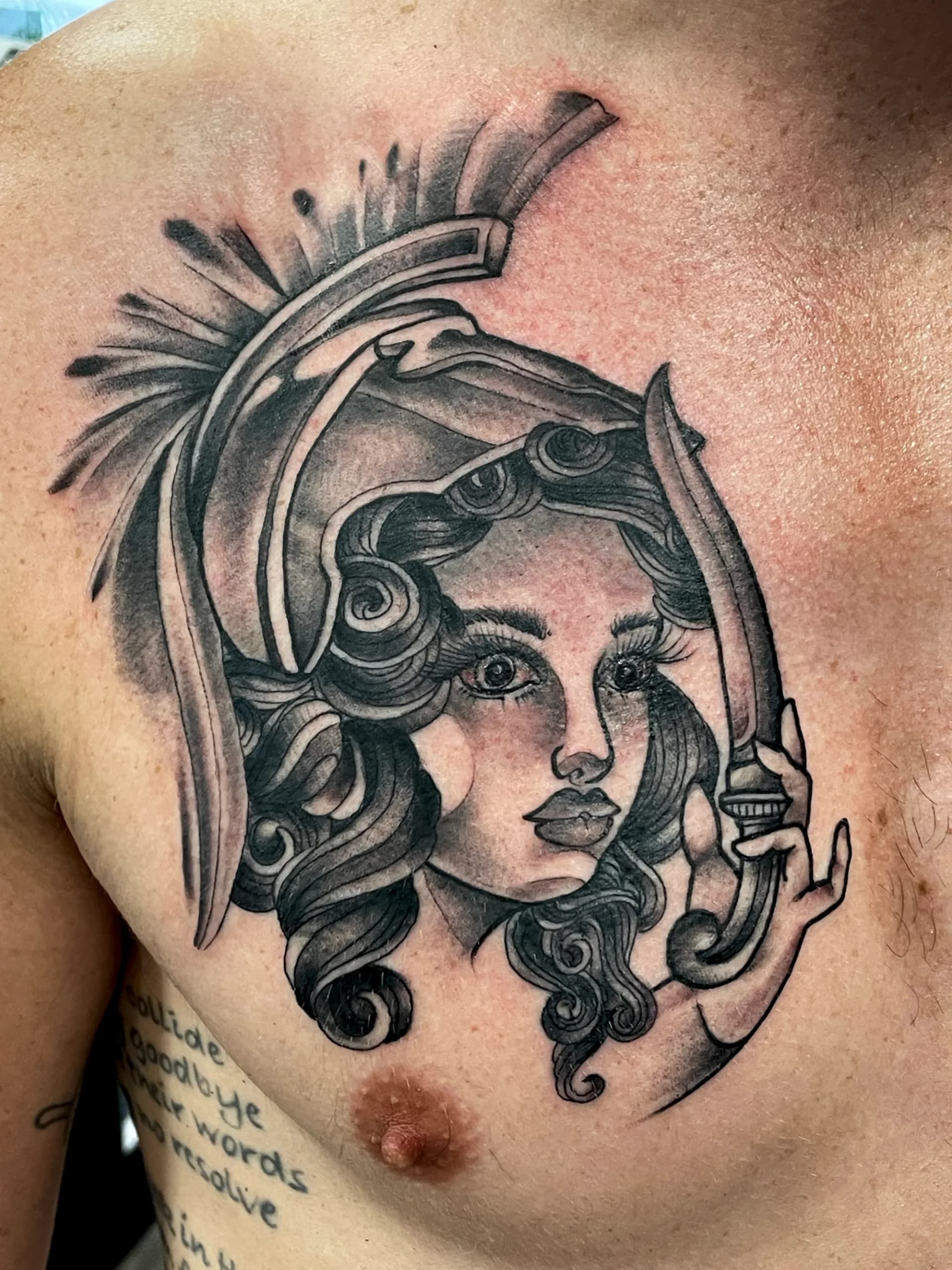 Athena warrior stylized portrait chest tattoo by Nate at Village Tattoo Company London Ontario