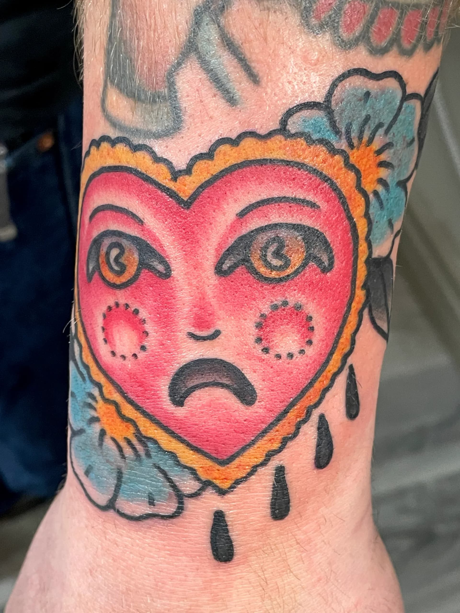 Crying heart traditional colour tattoo by Nate at Village Tattoo Company London Ontario