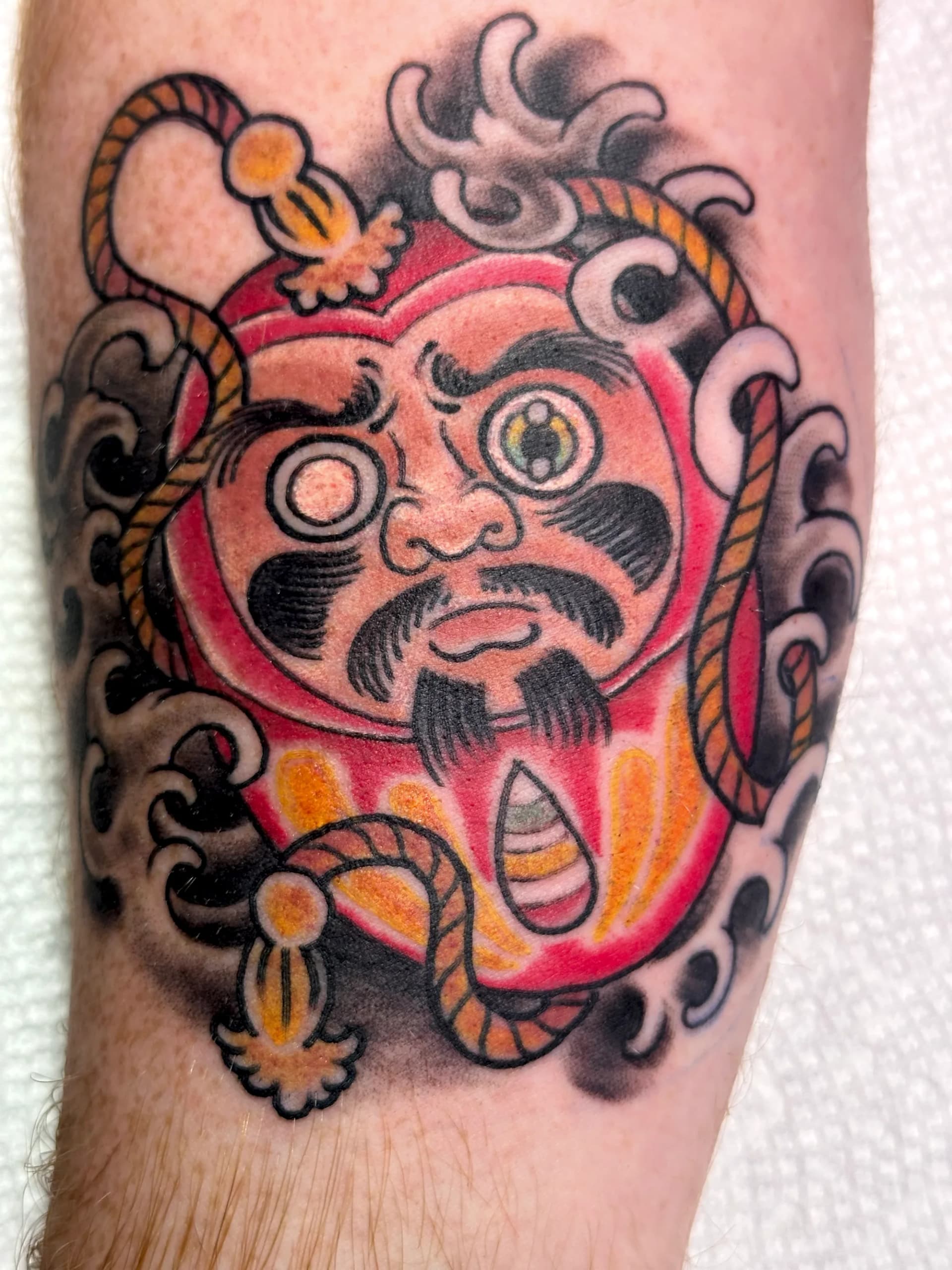 Daruma with waves Japanese colour tattoo by Nate at Village Tattoo Company London Ontario