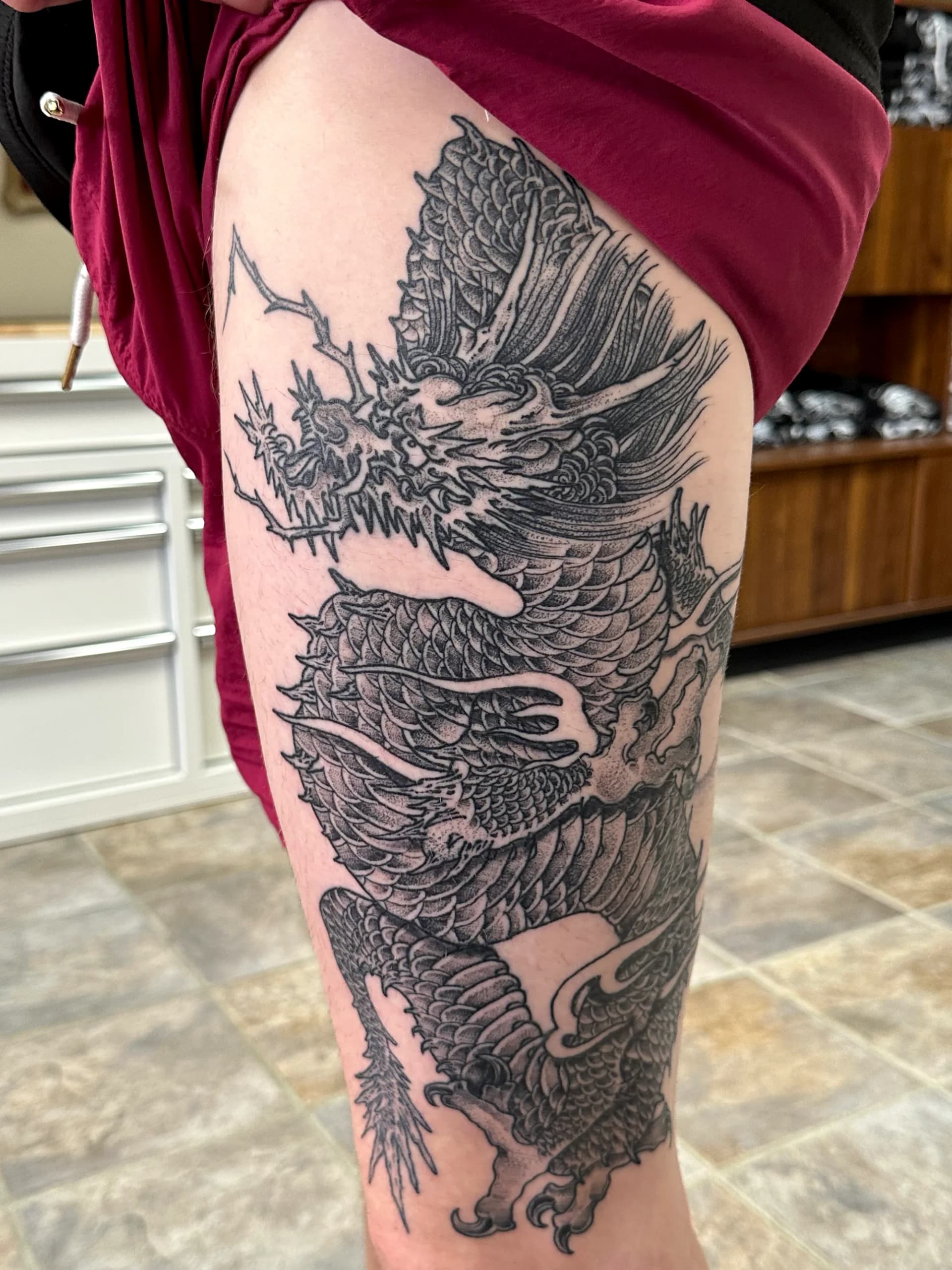 Dragon black and grey thigh tattoo by Nate at Village Tattoo Company London Ontario