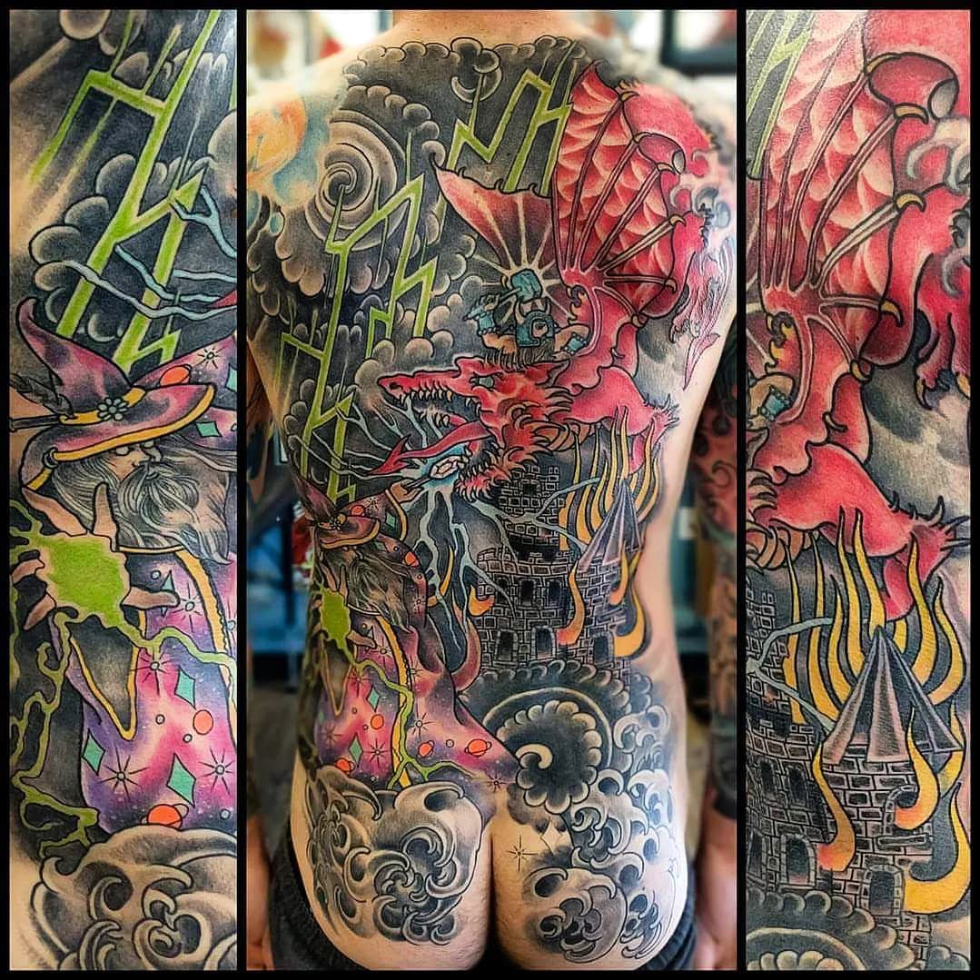 Dragon and castle full back piece tattoo in black and grey by Nate at Village Tattoo Company London Ontario