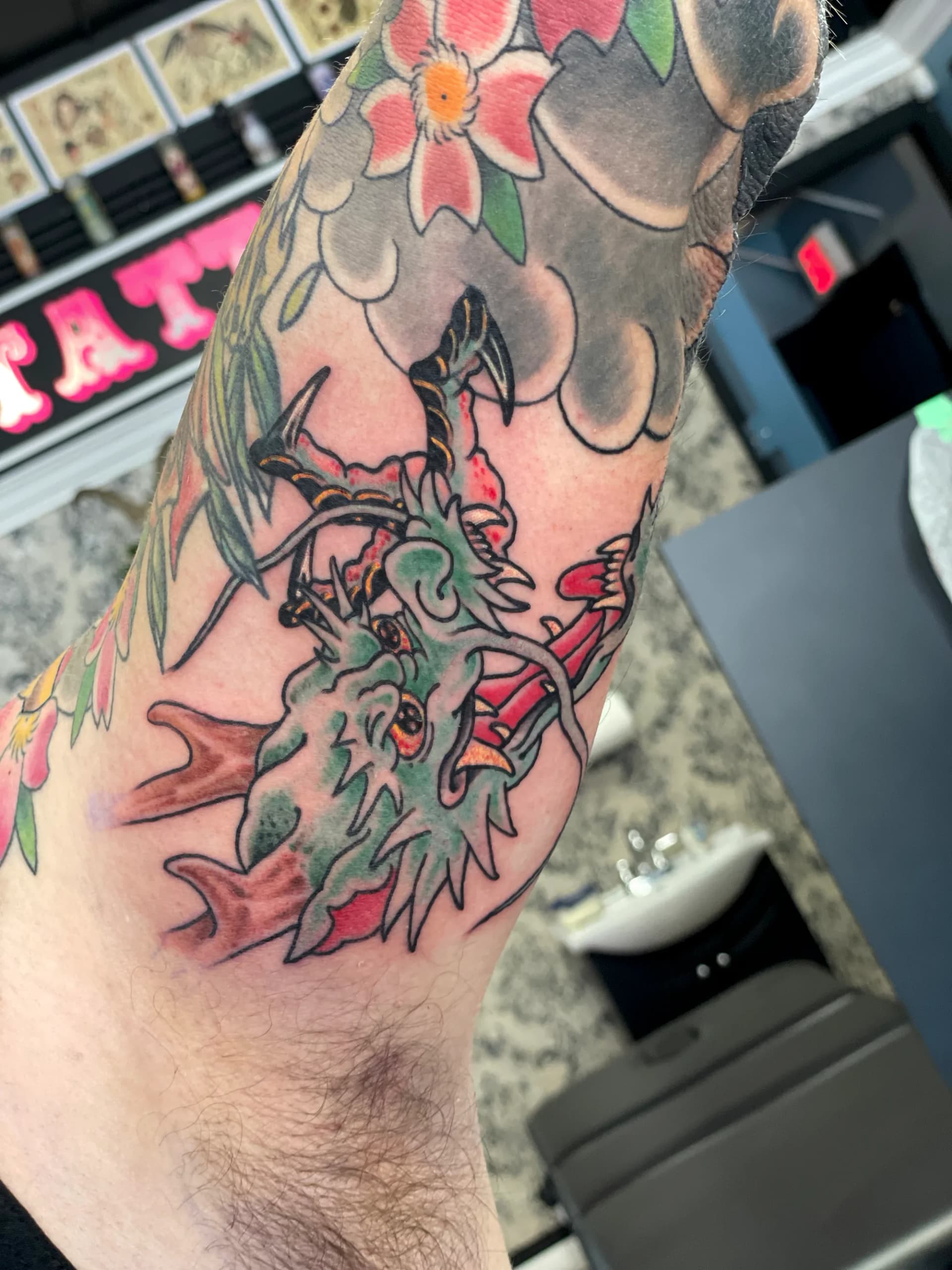 Dragon head and claw traditional tattoo by Nate at Village Tattoo Company London Ontario