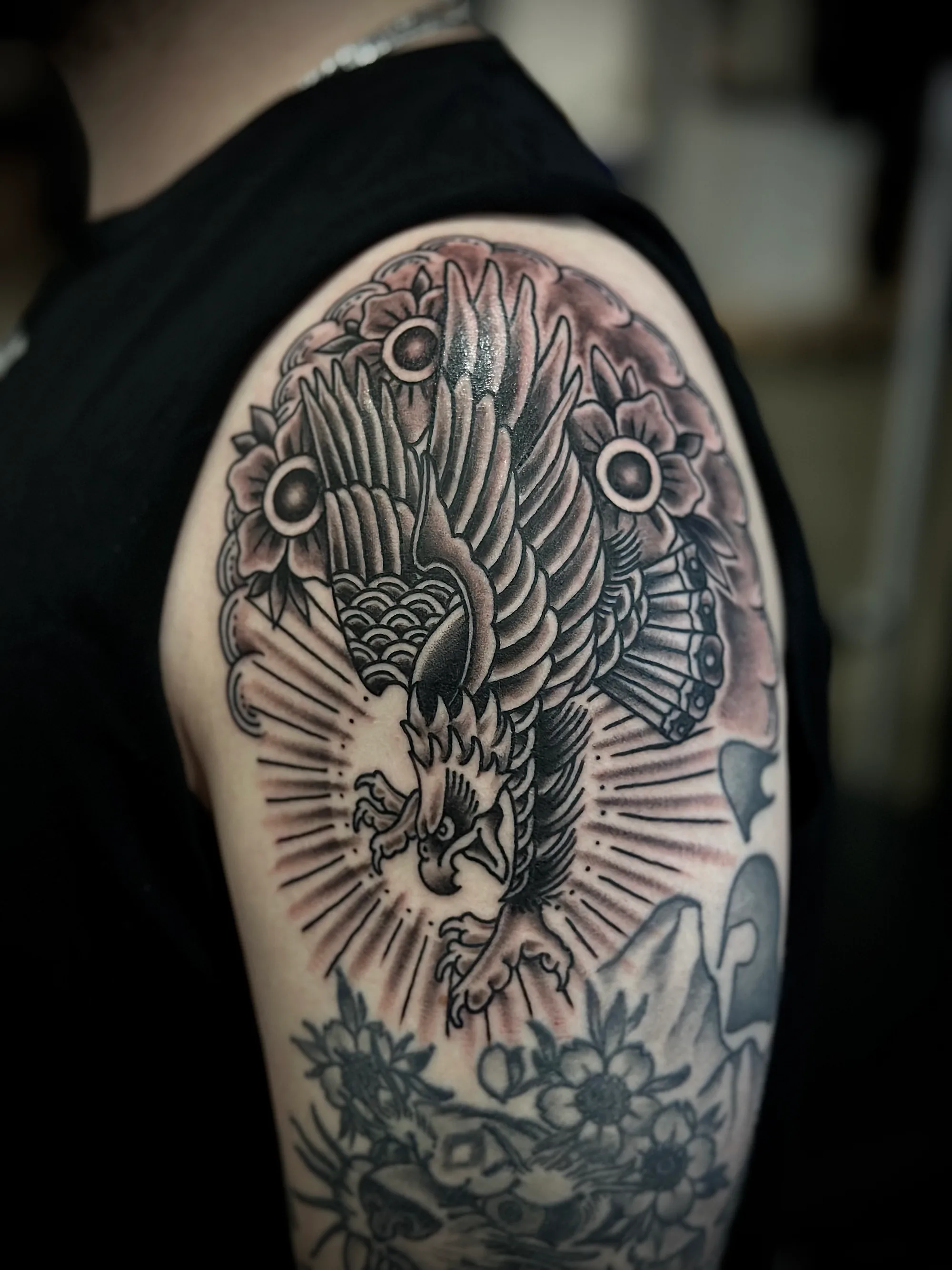 Eagle blackwork traditional back tattoo by Nate at Village Tattoo Company London Ontario