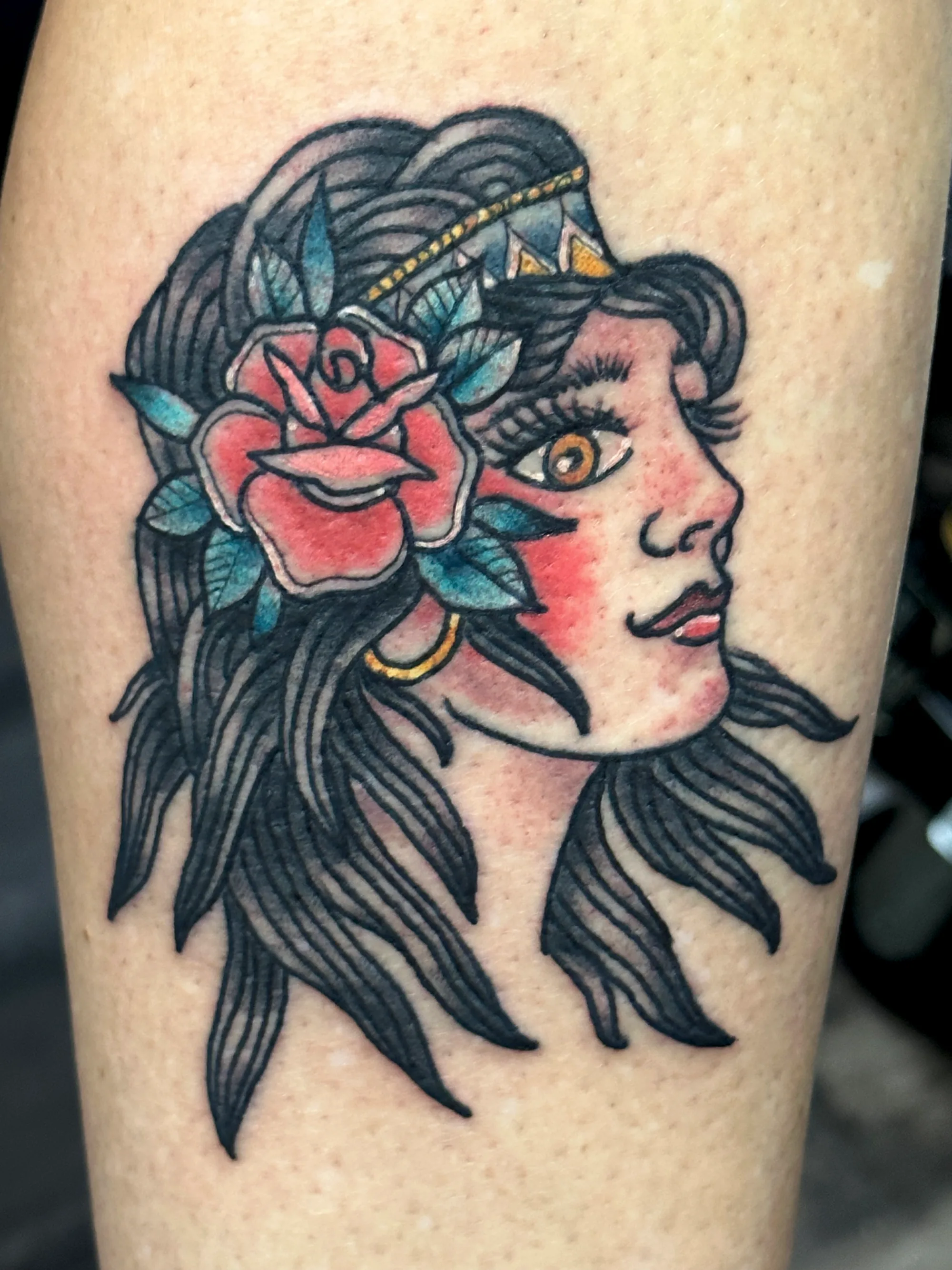 Traditional lady head upper arm tattoo by Nate at Village Tattoo Company London Ontario