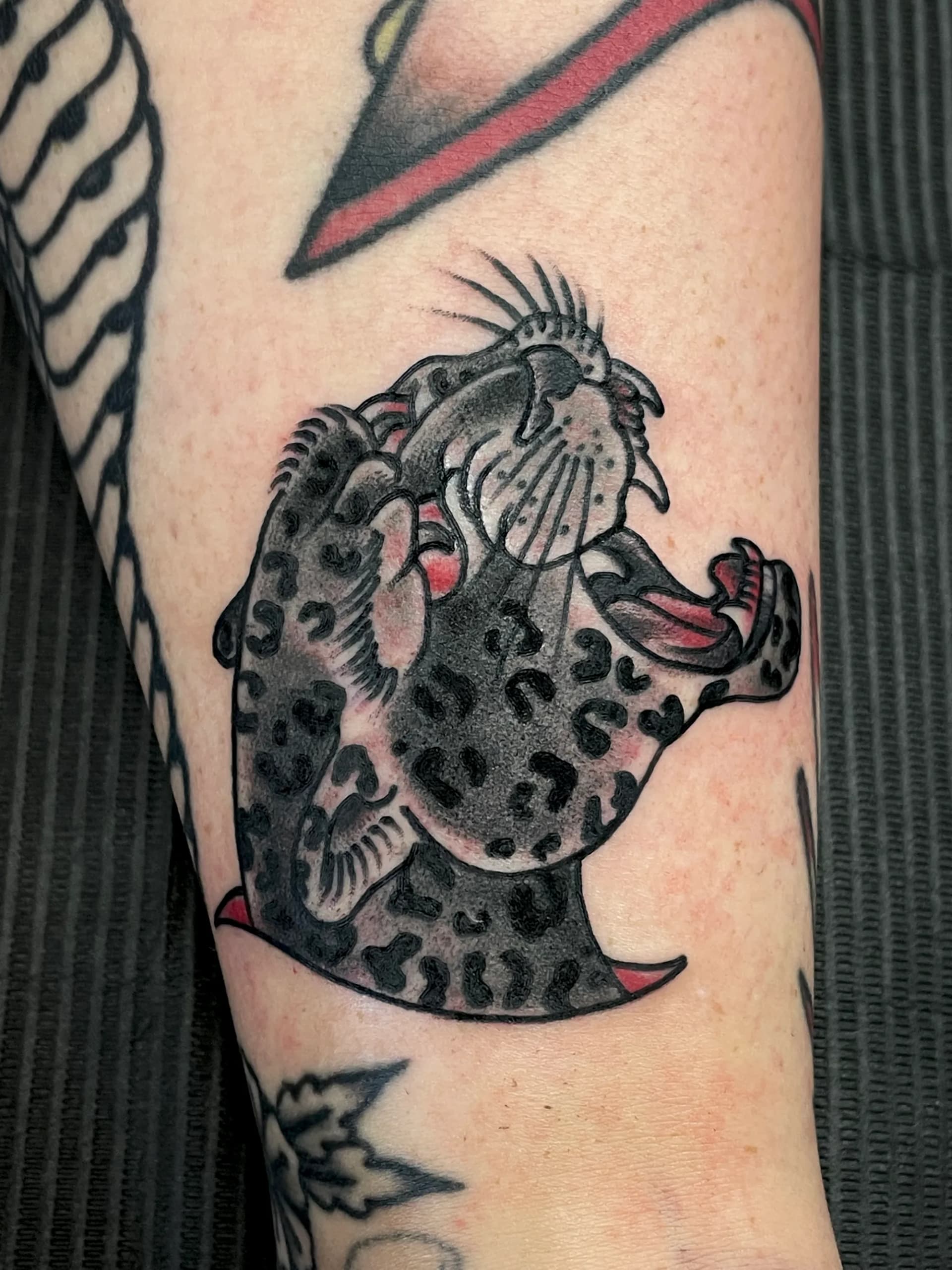 Leopard head black and grey traditional tattoo by Nate at Village Tattoo Company London Ontario