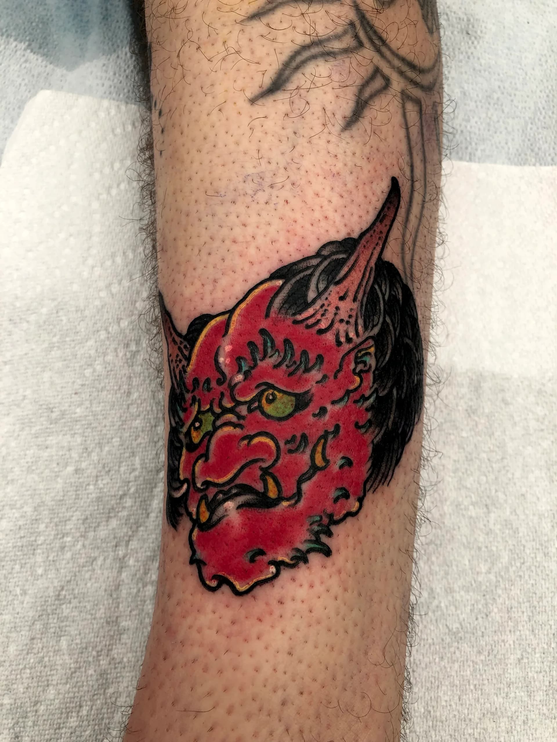 Red oni demon head Japanese colour sleeve tattoo by Nate at Village Tattoo Company London Ontario