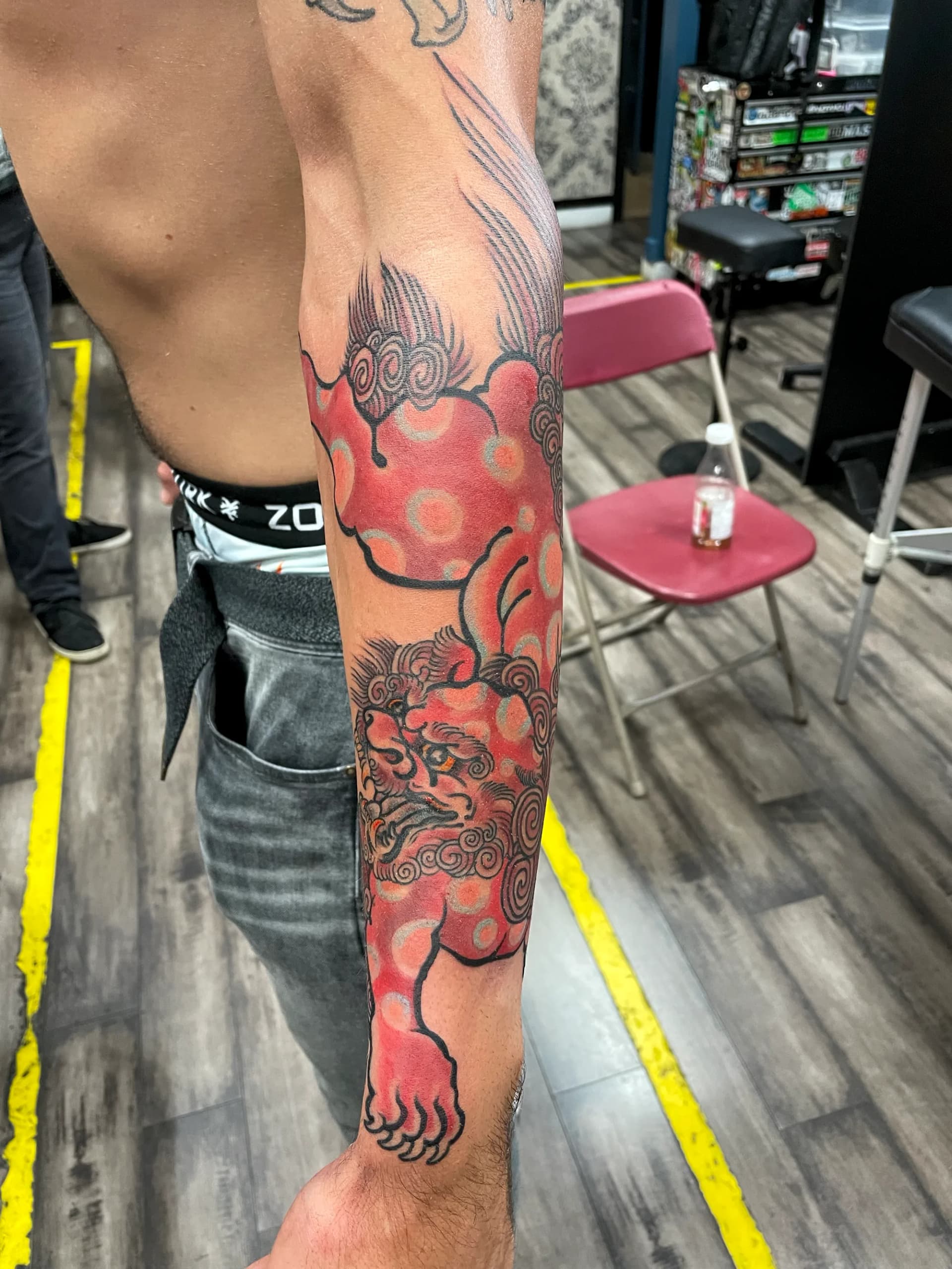 Red foo dog Japanese forearm tattoo by Nate at Village Tattoo Company London Ontario
