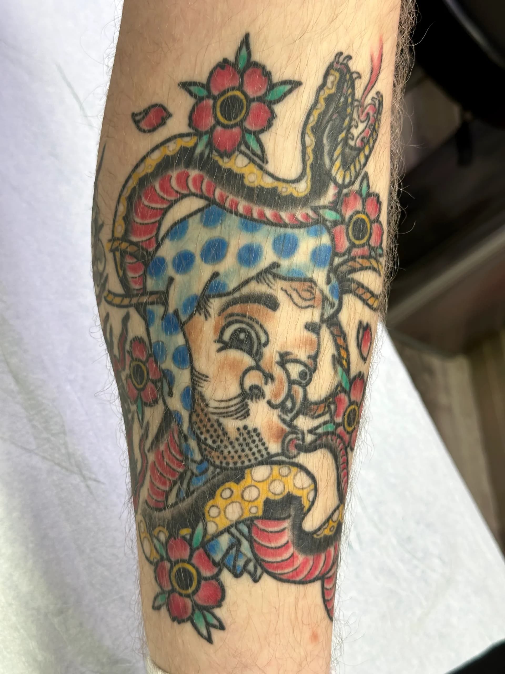 Samurai warrior with snake and flowers black and grey upper arm tattoo by Nate at Village Tattoo Company London Ontario