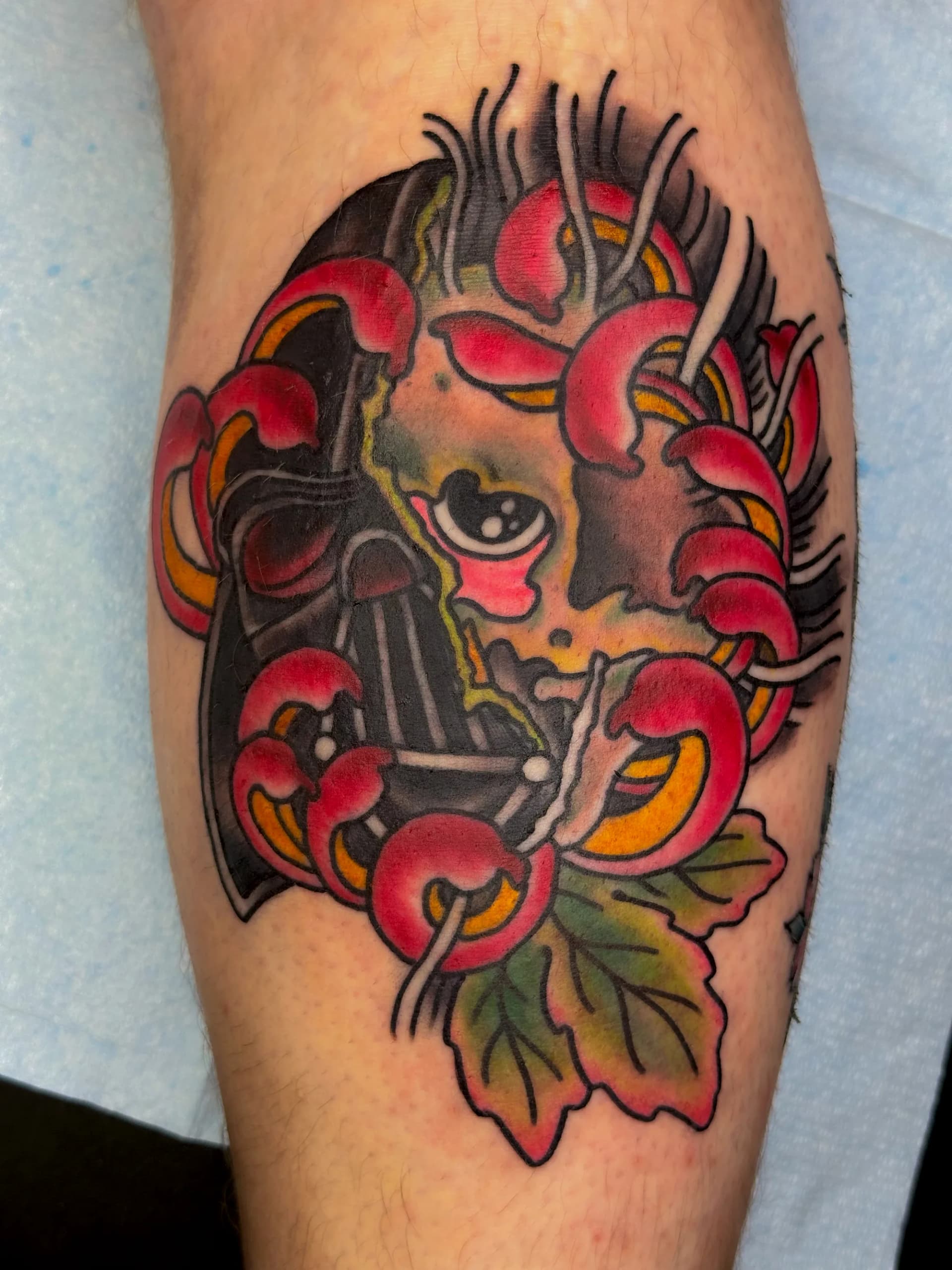 Skull mask traditional colour tattoo by Nate at Village Tattoo Company London Ontario