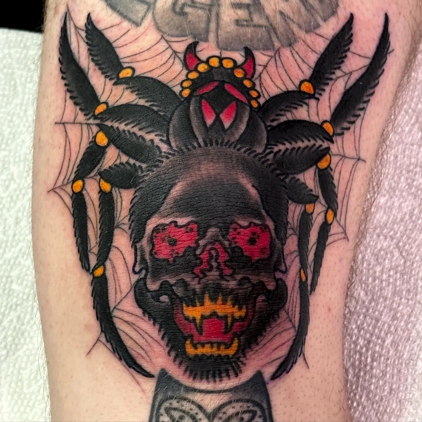 Skull with spider knee traditional tattoo by Nate at Village Tattoo Company London Ontario