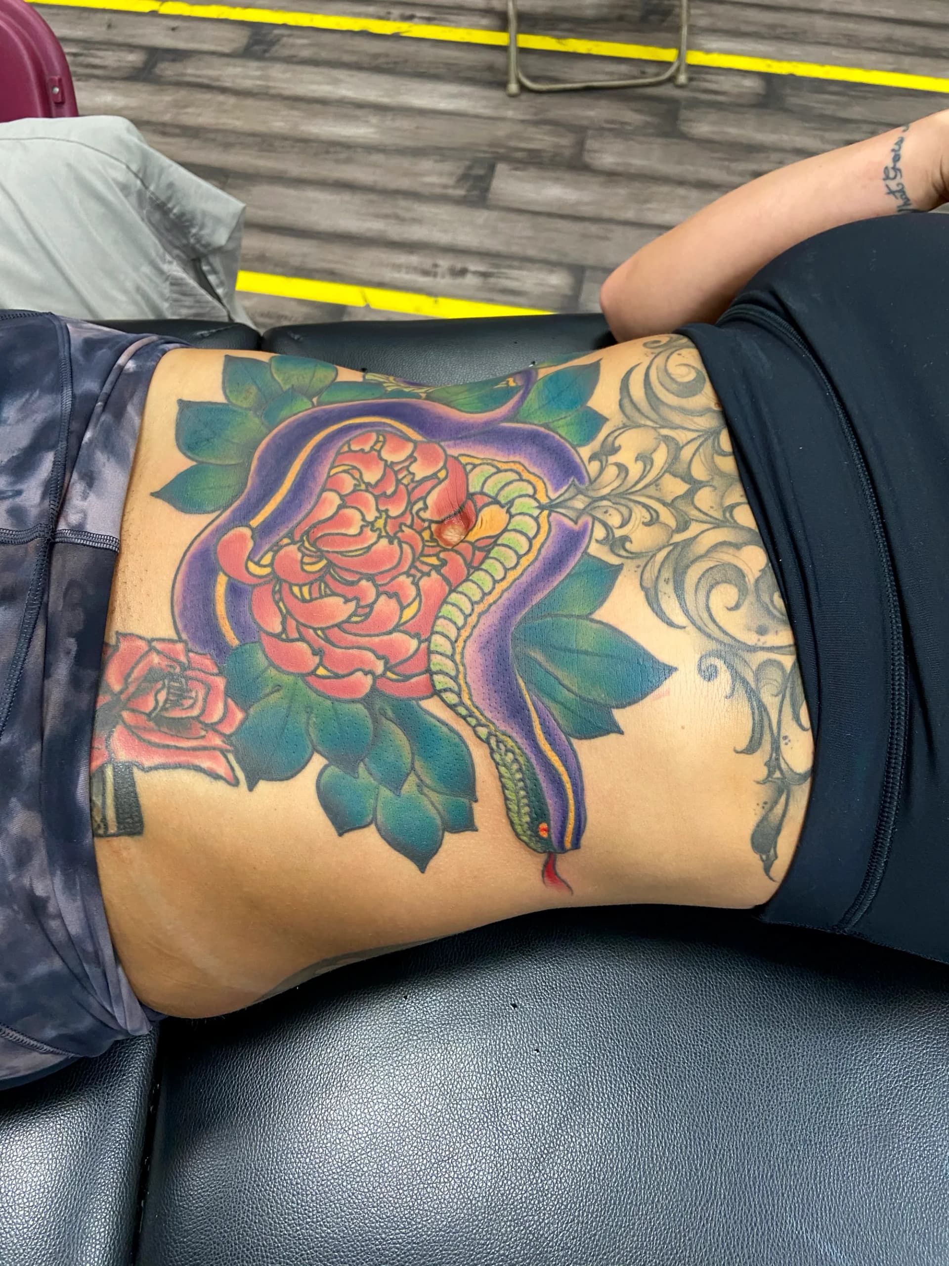 Snake and flower Japanese stomach tattoo by Nate at Village Tattoo Company London Ontario