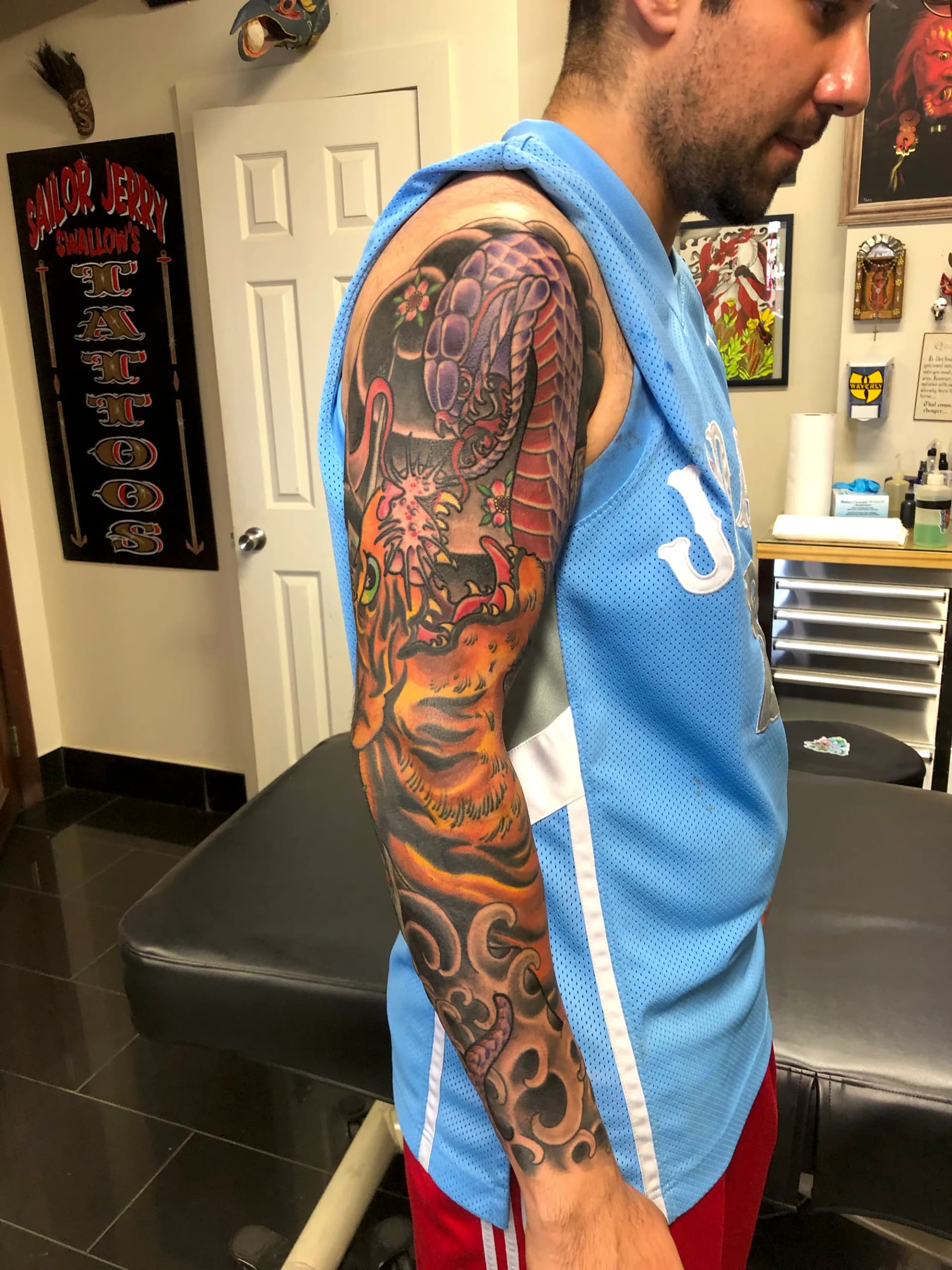 Tiger and snake Japanese colour half sleeve tattoo by Nate at Village Tattoo Company London Ontario